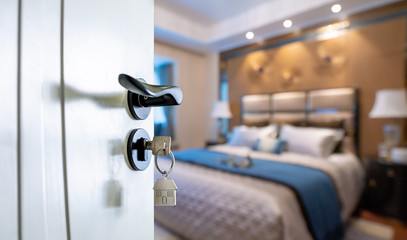 Open door with keys, key in keyhole