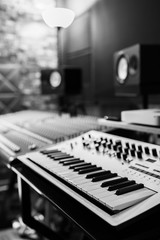 keyboard synthesizer in recording studio. black and white