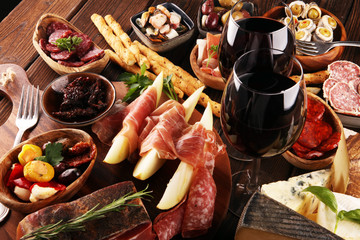Italian antipasti wine snacks set. Cheese variety, Mediterranean olives, seafood salad, Prosciutto...