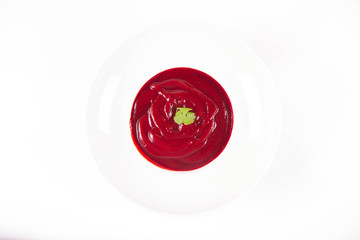 Beetroot cream soup decorated with coriander leaf