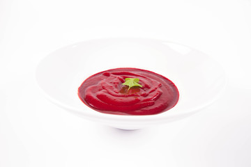 Beetroot cream soup decorated with coriander leaf