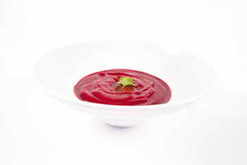 Beetroot cream soup decorated with coriander leaf