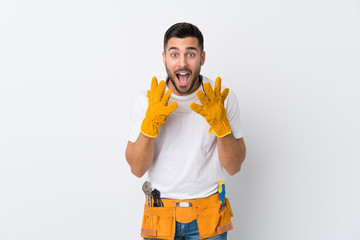 Craftsmen or electrician man over isolated white background with surprise facial expression