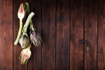 artichokes on rustic background. fresh raw organic artichoke flower.