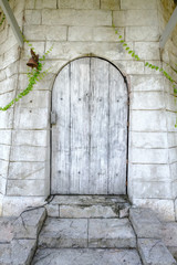Old wooden door with stone wall