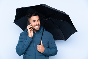 Man holding an umbrella over isolated background