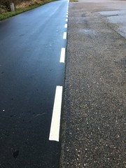 asphalt road with yellow lines