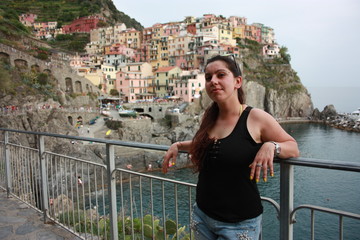Fototapeta na wymiar brunette caucasian curvy girl on a lookout point on the Cinque Terre coast in summer