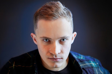 Portrait of a young man with an intense gaze.