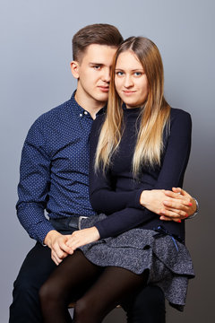 The guy put girl on his lap for a photoshoot.