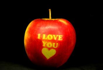 Red Apple with text I LOVE YOU on black background. I love you apple. Apple for Valentine's Day