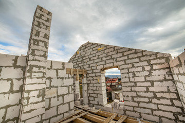 Building site of a house under construction made from white foam concrete blocks.