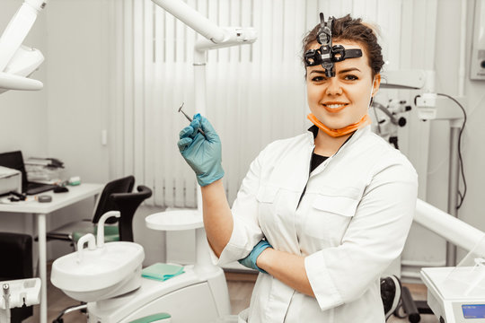 Young woman dentist doctor in professional uniform at workplace. Healthcare Workplace equipment for a doctor. Dentistry