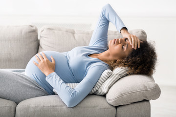 Pregnancy and migraine. Woman suffering from severe headache