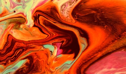 maroon-orange abstract background. Acrylic paint flows freely and creates an interesting pattern....