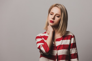 beautiful Surprised blonde woman in striped jacket