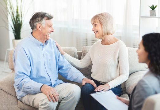 Happy mature couple laughing during successful therapy