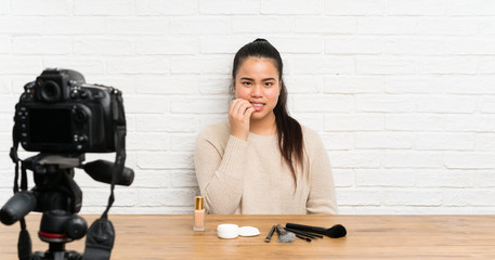 Young blogger Asian girl recording a video tutorial nervous and scared