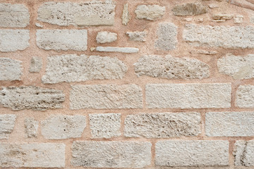wall of the historic building is made of white stones. Texture.