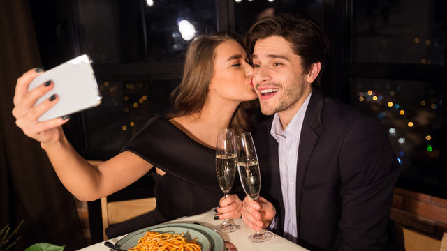 Happy romantic couple making selfie photo on cellphone