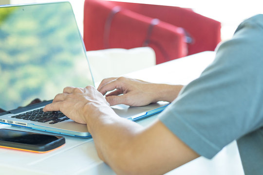 Freelance man using multichannel online network 5G technology internet tablet and laptop working in nature park during relax day time.Sunlight morning, work from anywhere life style concept.