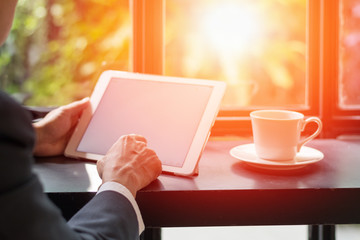 Official professional Business man using multichannel services with internet wifi 5G on smartphone and online tablet in coffee shop.City lifestyle businessman hands working using mobile phone concept