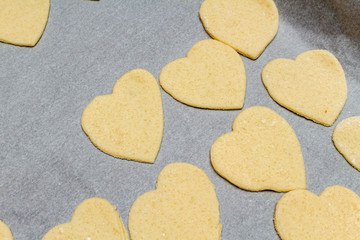 Obraz premium Hearts shape cookies cooking process. Valentines day gift preparation dating.