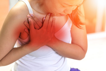 Woman's hand on chest with red spot as suffering on chest pain. Female suffer from heart...