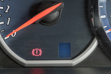 Naklejka premium Closeup at handbrake signal lights on the car dashboard.