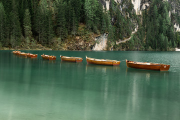 Lago di Braies in South Tyrol, Italy with it's famous floating wooden boats and turquoise water