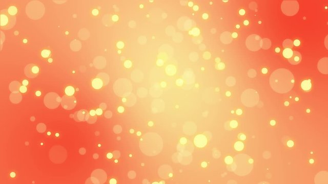 Bright animated yellow light bokeh particles floating on orange background.
