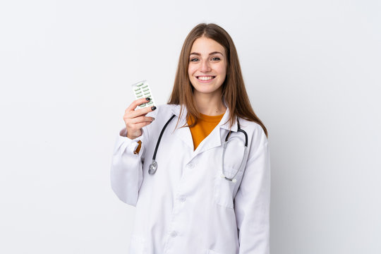 Young Woman Over Isolated Background Wearing A Doctor Gown And Holding Pills