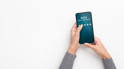 Girl holding mobile phone and evaluating service as two star