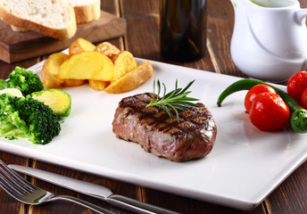 piece of meat with potato and tomato
