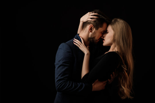 elegant couple in the tender passion. man and beautiful woman kissing