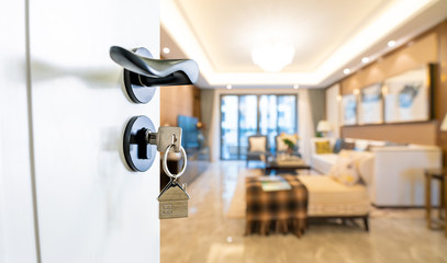 Open door with keys, key in keyhole