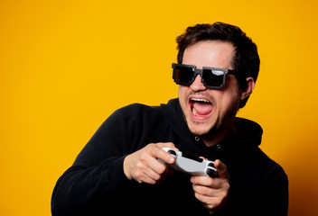 man sunglasses keen plays with a joystick