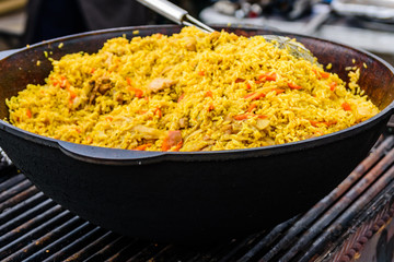 Big pan with pilaf on street festival