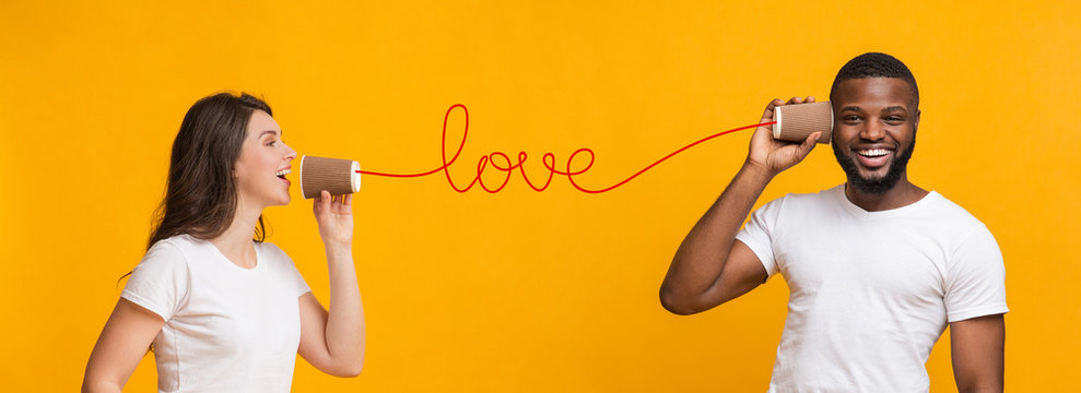 Romantic girlfriend sending love message to boyfriend with tin phone