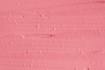 Soft pink cosmetic clay (rhassoul, facial mask, face cream, body wrap) texture close up, selective...