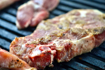 preparing meat on a coal barbeque