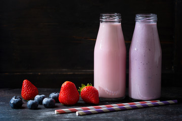 bottles of smoothies with fresh berries