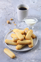 Vanilla Butter Finger Ladies Cookies, grey plate, milk, napkin, little bucket, grey background.