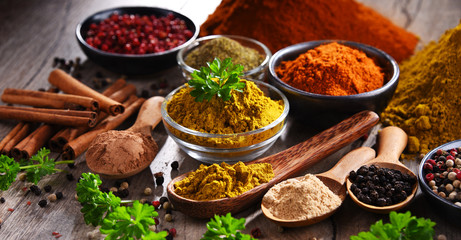 Variety of spices on kitchen table - obrazy, fototapety, plakaty