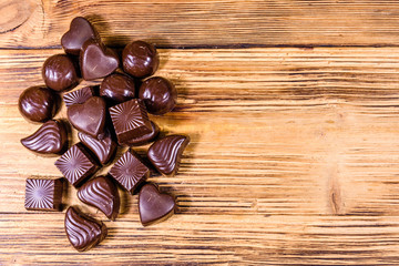 Fototapeta na wymiar Heap of chocolate candies on a wooden table