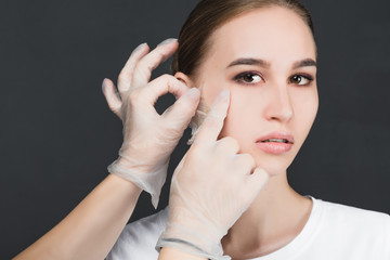 Portrait of a young girl with a mask removed from her face.