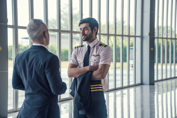 Pilot  talking together with flight attendant chief at airport .Success, career and Business trip concept © supAVADEE BUTRADEE