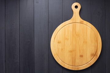 pizza cutting board at rustic wooden plank background