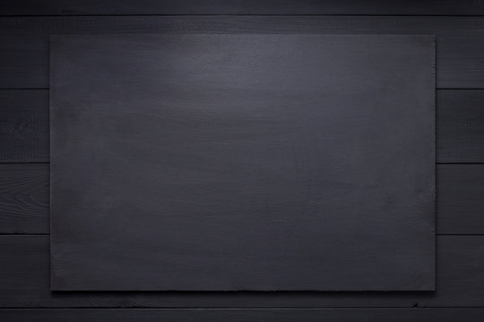 wooden nameplate at black background texture