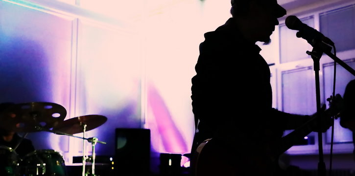 Music group on stage, colorful background